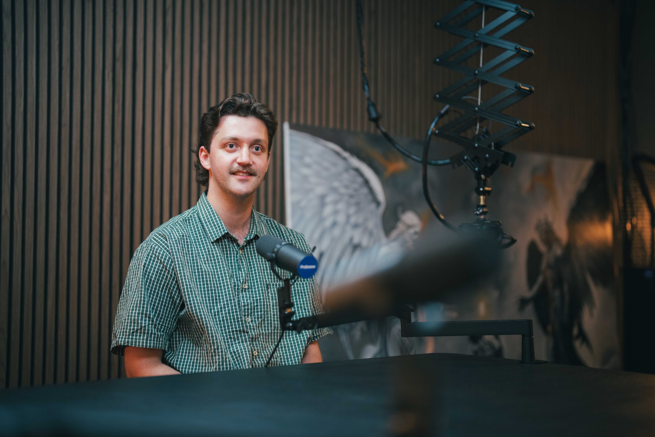 Josh Hay recording a podcast in front of a microphone at Podwave Studios West Leederville Perth