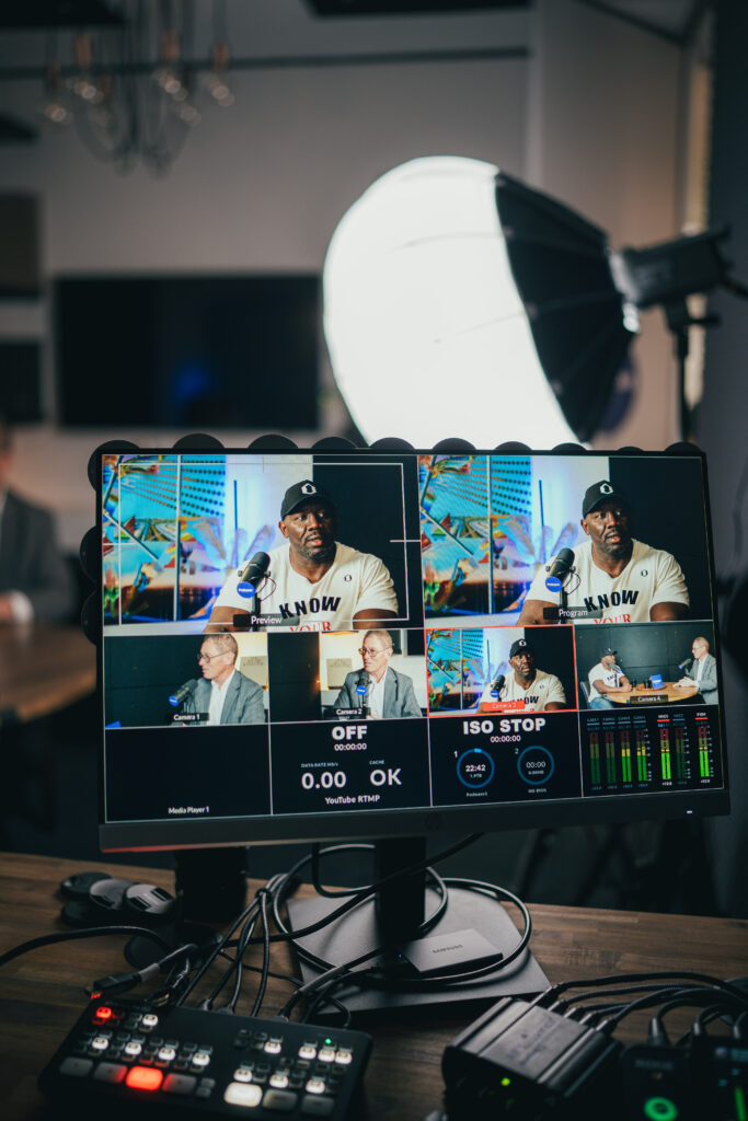 Producer monitor showing Tom's podcast video footage being reviewed in post-production at Podwave Studios West Perth